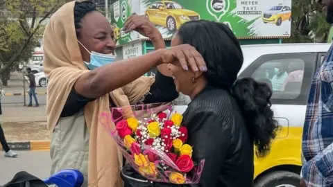 Getty Images Passengers arriving from Tigray are greeted by relatives at the Bole International Airport in Addis Ababa on December 28, 2022