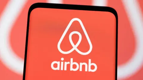 Reuters The Airbnb logo is seen displayed in an illustration.