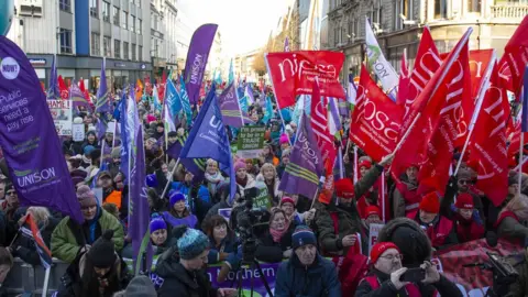 Mark Marlow/EPA-EFE/REX/Shutterstock Striking workers attended a union rally in front of Belfast City Hall on Thursday