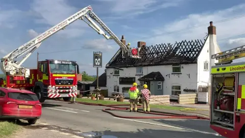 BBC  Fire crews at the Cross Keys Inn