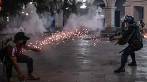 EPA Protesters in favour of Pedro Castillo and against Congress, clash with members of the police in the streets of downtown in Lima, Peru, 11 December 2022.