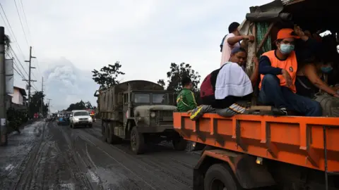 AFP Residents aboard a government truck evacuate to a safer place after Taal volcano began spewing ash over Tanauan town, Batangas province south of Manila on January 13