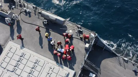 EPA A handout photo made available by Japan"s Defense Ministry, showing US military personnel preparing to transfer an injured person on board the USS Fitzgerald