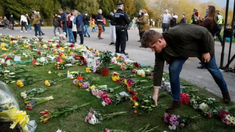 Reuters A person leaves flowers outside Windsor Castle