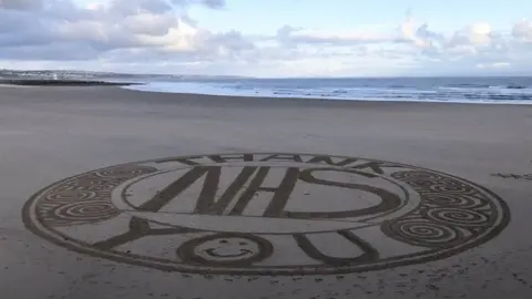 Porthcawl RNLI Sand art in Sandy Bay in Porthcawl