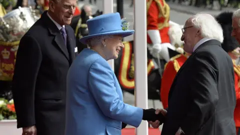 TOBY MELVILLE President Higgins shakes hands with the Queen while Prince Philip looks on