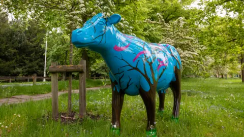 Cows About Cambridge Entwining of Two Worlds cow sculpture