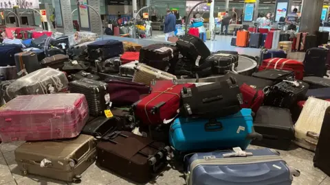 Getty Images Bags piled up at Heathrow