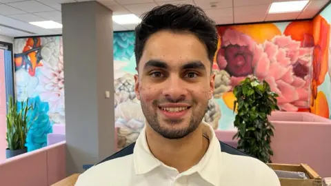 Jeril Laiju, Tax Associate at Forrest Brown, smiling at the camera wearing a white shirt