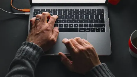 A man uses a laptop