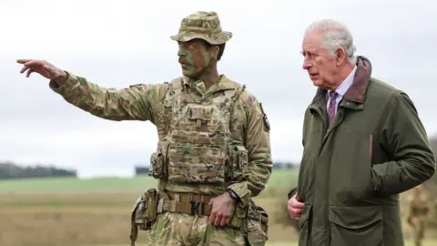 PA Media King Charles III meets Major Tony Harris ahead of a trench attack and defence simulation