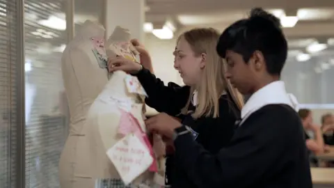 BBC Children pinning material on a mannequin