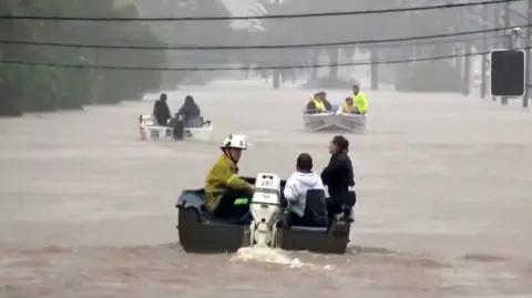 People rescued by boat in Lismore street