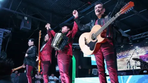 Getty Images Los Tigres del Norte on stage - four musicians