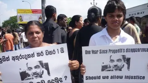 bbc Sandhya and Sanjaya Eknaligoda hold pictures of Prageeth Eknaligoda during a recent demonstration