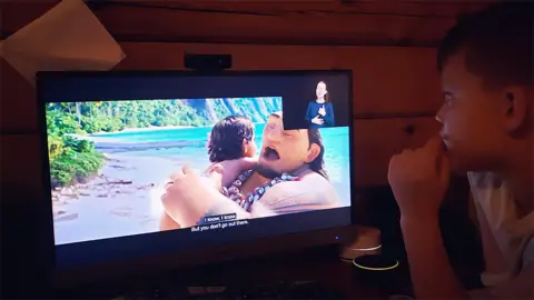 Jarod Mills Toby watching a film using the SignUp interpreter in the corner