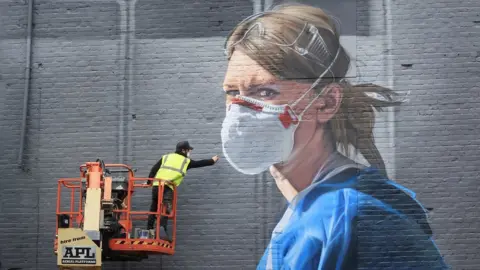 Danny Lawson/PA Wire Mural being painted in Manchester