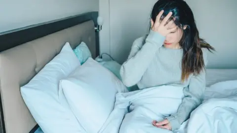 Getty Images Woman ill in bed