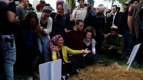 Reuters Mourners attend the funeral of Hillel Yaniv and Yigal Yaniv, Israeli brothers from the Har Bracha settlement, who were killed by a Palestinian gunman as they were driving in the occupied West Bank (27 February 2023)