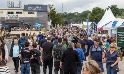 Hundreds of people are visible walking between stalls at the Bath and West Show