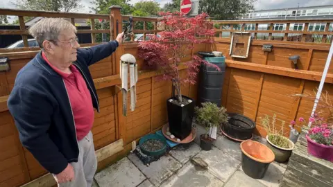 Kevin Shoesmith/BBC Barry Maddison in his Grimsby garden