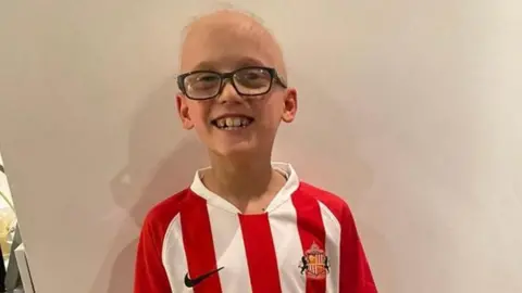 Family handout A boy smiles while wearing a Sunderland shirt