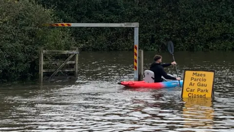 Kayaker in flooded car park