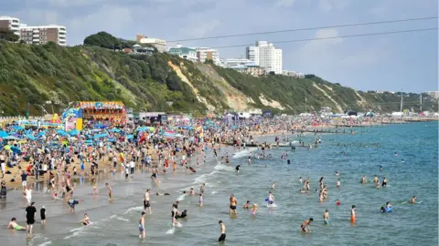 PA Thousands of people on the beach at Bournemouth in August 2018