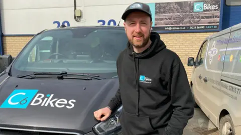 Jozef Hall/BBC Steve Heathcock in a black cap and black hooded top