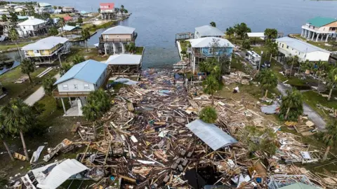 Getty Images An aerial view of damaged houses next to the coast