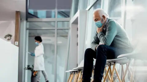 Getty Images an older man waiting in hospital