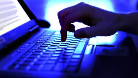 Bill Hinton/Getty Images Person typing on computer