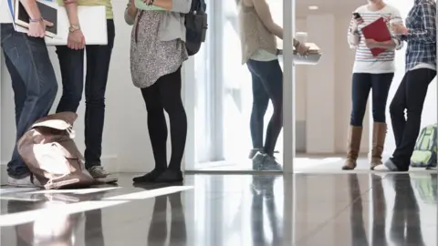 Getty Images Students standing in corridor