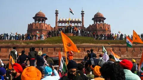 Getty Images Farmers take part in a tractor rally as they continue to protest against the central government's recent agricultural reforms, in front of Red Fort in New Delhi on January 26, 2021.