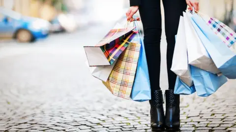 Getty Images Woman with shopping bags