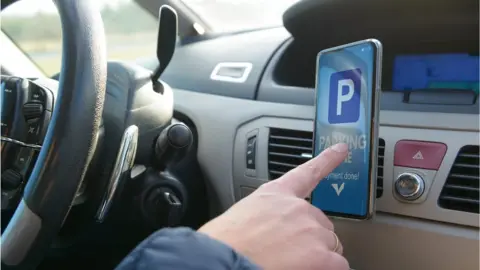 Getty Images Driver uses parking app