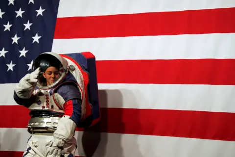 Carlos Jasso/Reuters Advanced Space Suit Engineer Kristine Davis wears the xEMU prototype space suit during its presentation at NASA headquarters