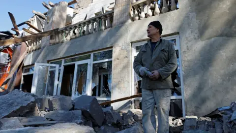 Reuters A man removes debris from a building destroyed by shelling in Luhansk, eastern Ukraine