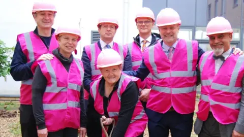 Kettering General Hospital Glennis Hopper with some of her fundraising team cutting the first turf at the Kettering General Hospital soon be be breast cancer waiting area