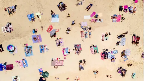 Getty Images holidaymakers on beach