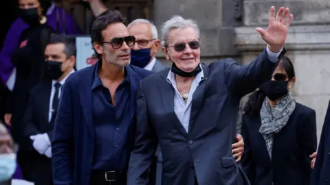 THOMAS SAMSON/AFP Alain Delon (R) his son Anthony Delon arrives for the funeral ceremony for late French actor Jean-Paul Belmondo at the Saint-Germain-des-Pres church in Paris on September 10, 2021