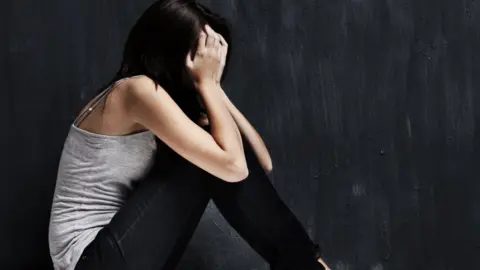 Getty Images woman with head in hands