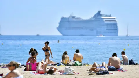 Getty Images Sun bathers on beach