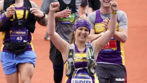 PA Media Lindsey Burrow crossing the finish line