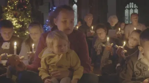 Church of England Children and parents at a Christingle service