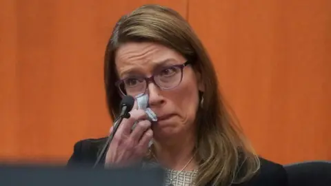 Getty Images Shae Herath wipes away tears as she testifies on Friday