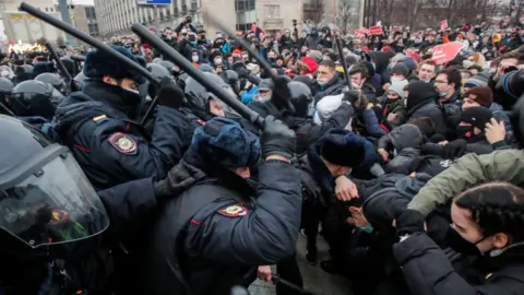 EPA Law enforcement officers clash with participants using batons in Moscow protest