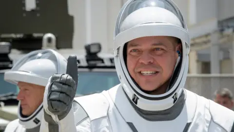 Astronauts Rob Behnken, foreground, and Doug Hurley, wearing SpaceX spacesuits on 30 May
