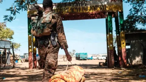 AFP An Ethiopian solider carrying a mattress - November 2020