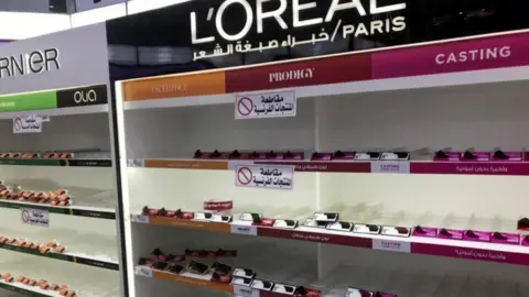 Reuters Empty shelves were seen where French products were displayed at Kuwaiti supermarkets